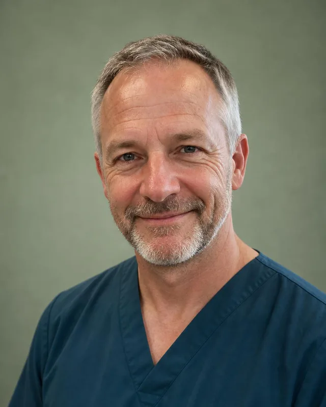 Nurse headshot: man in teal scrubs against a sage green backdrop